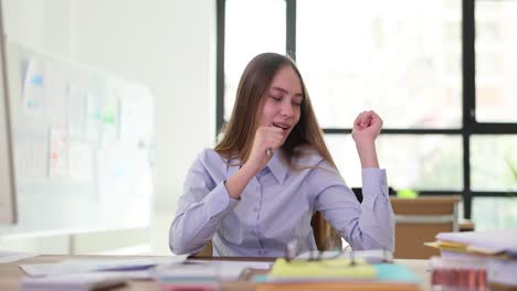 young woman expressing a range of emotions at her office desk