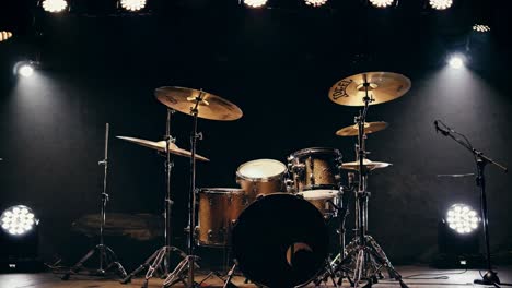 Low-angle shot of a drum set on stage under dramatic lighting, creating a moody atmosphere, perfect