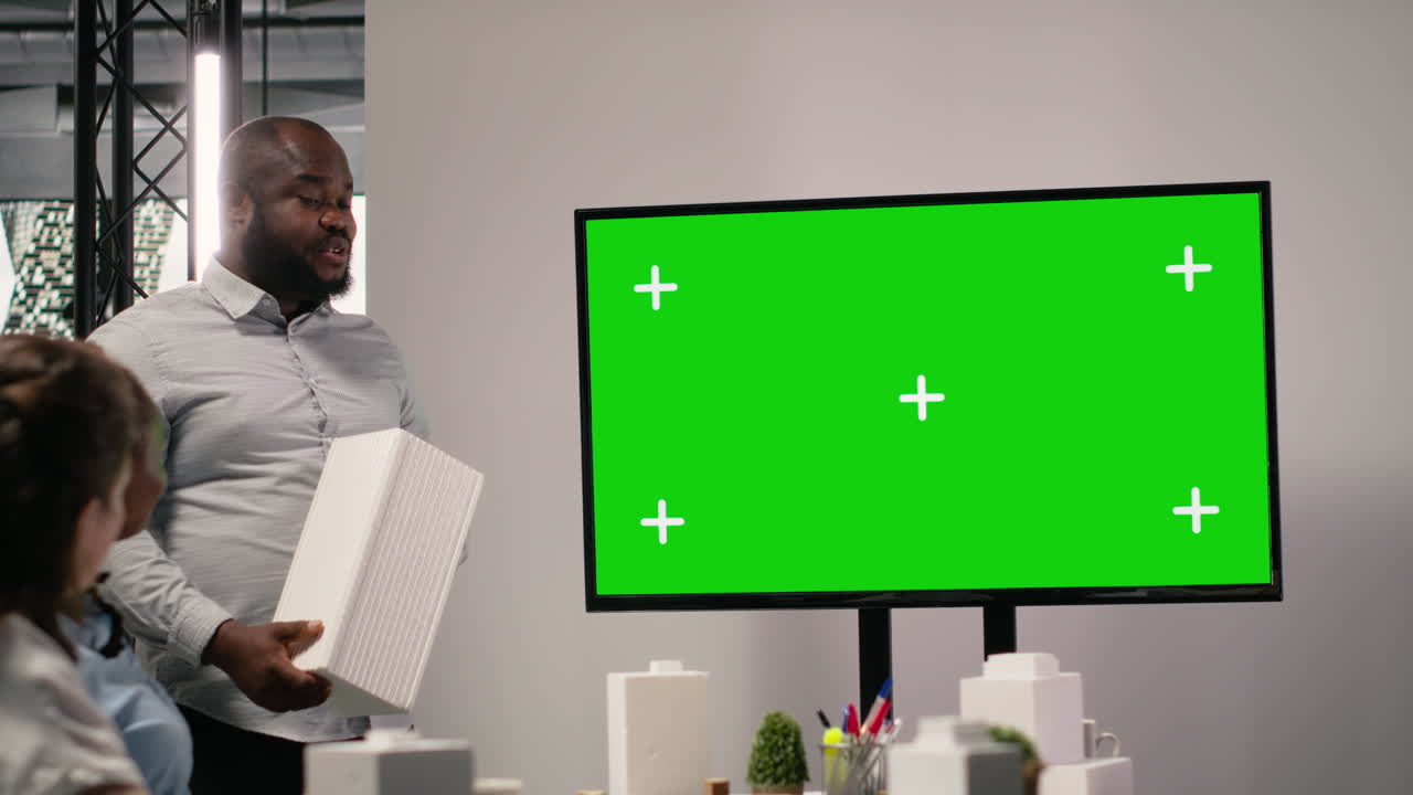 Business meeting with green screen display
