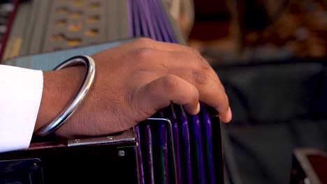 a sikh playing harmonium during kirtan of guru granth sahib