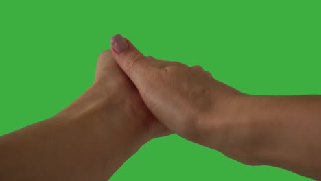 hands clapping over green background