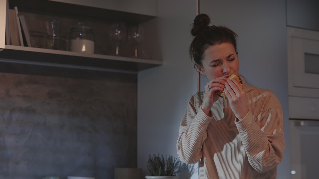 Woman Eating Late Night Snack in Kitchen