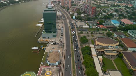 Traffic-and-cityscape-of-Falomo-Bridge,-Lagos-Law-school-and-the-Civic-centre-tower-in-Lagos-Nigeria