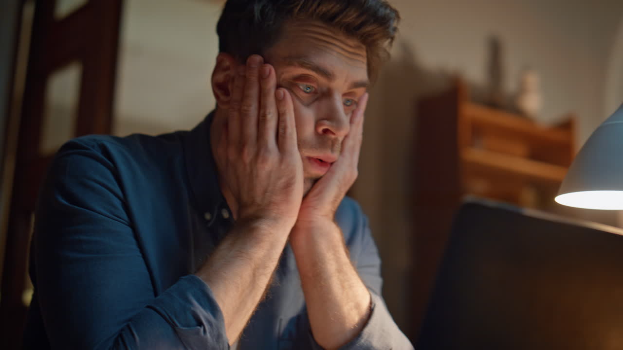 Nervous employee looking computer screen in night home closeup. Work problems