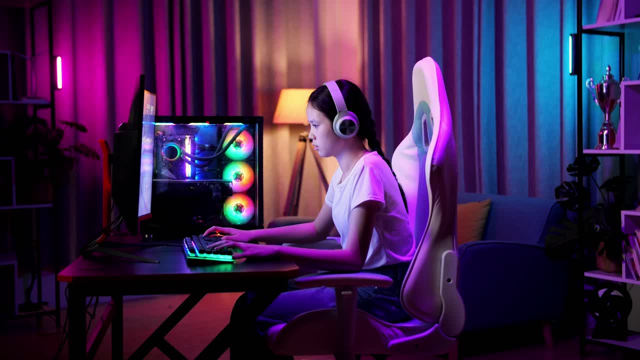 una adolescente asiática pierde mientras juega videojuegos en la computadora.