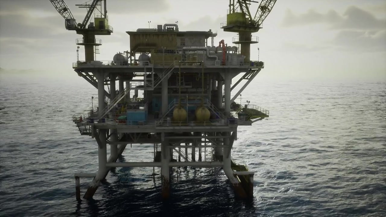 Gyldent morgenlys indhyller en offshore olieudvindingsinstallation.