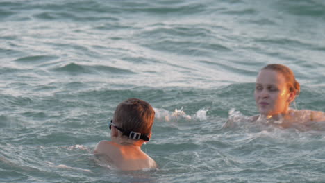 boy having fun in water with mum