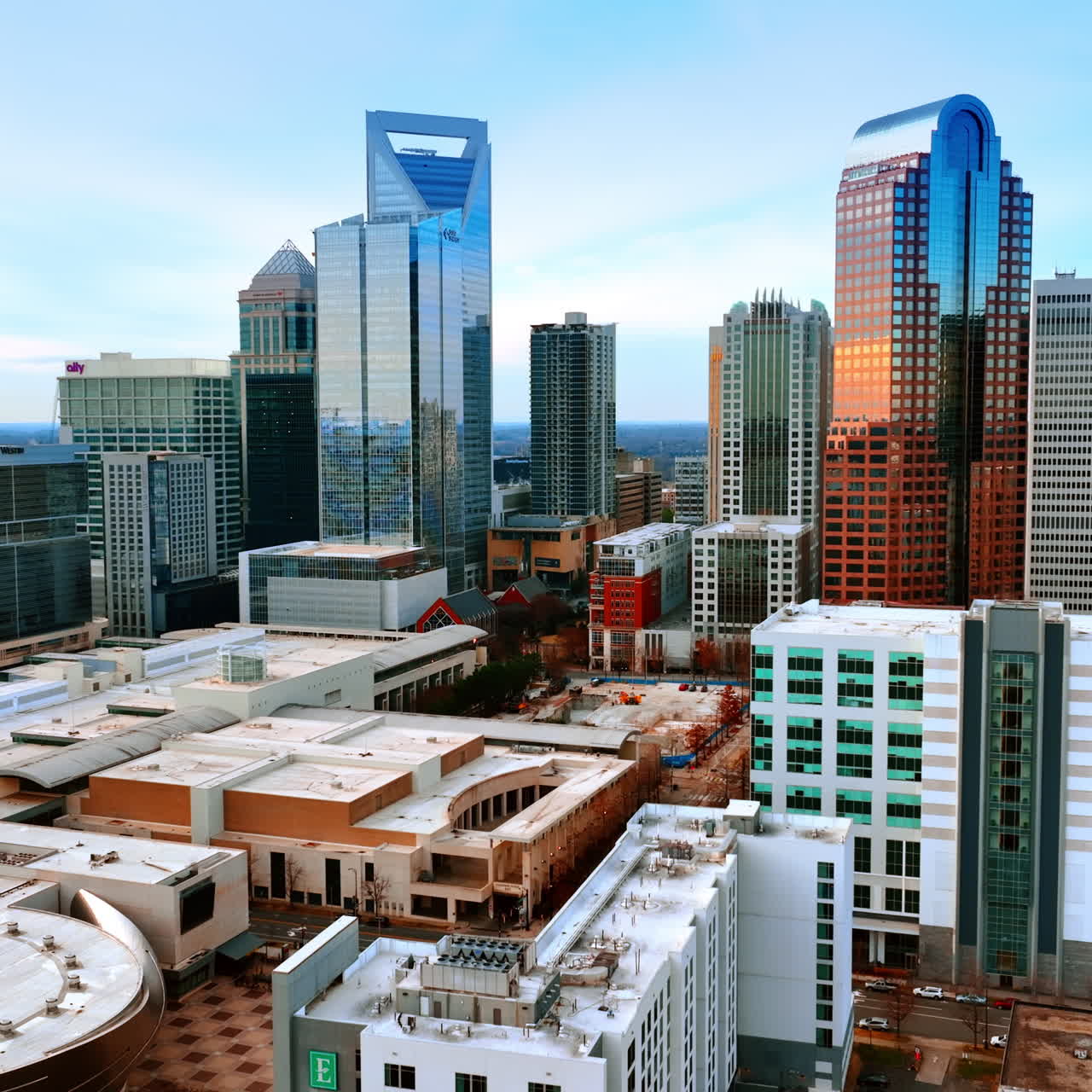 Low-rise architecture neighboring with beautiful modern skyscrapers. Cityscape of Charlotte, North Carolina, USA from top.