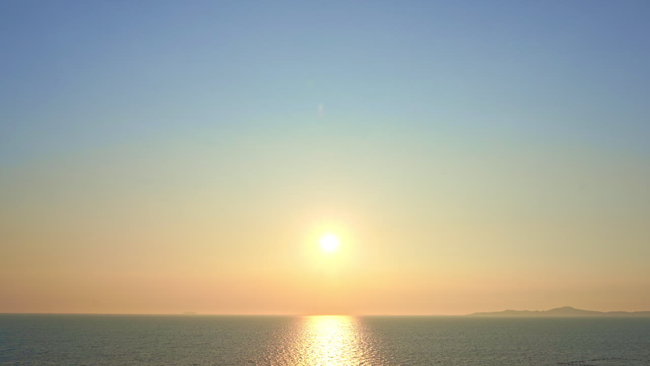 A golden sunset reflects off the ocean waters