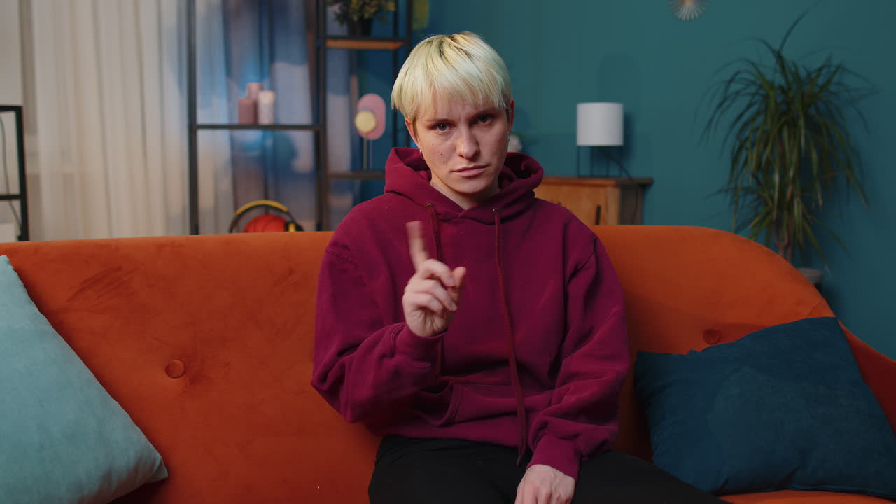Displeased upset woman reacting to unpleasant awful idea, dismiss bad idea, wave hand, shake head No