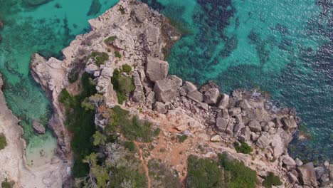 Top-down-of-amazing-Mallorca-coastline-with-clear-blue-water-at-S'Almonia,-aerial