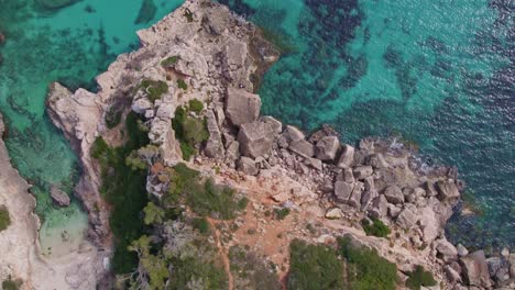 top down of amazing mallorca coastline with clear blue water at s'almonia, aerial