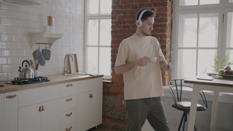 man dancing in the kitchen while listening to music