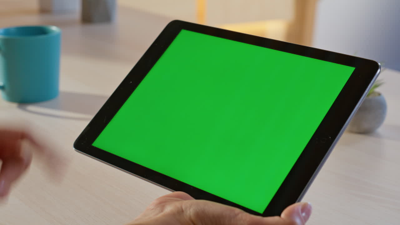 Tablet with Green Screen on Desk