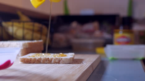 Honey-being-drizzled-onto-multigrain-bread