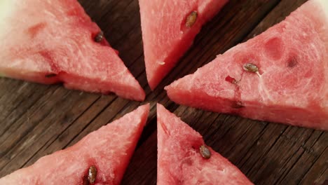Slices-of-watermelon-arranged-on-wooden-table