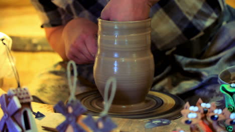 potter making clay vase. male potter make ceramic dishes. making clay pitcher