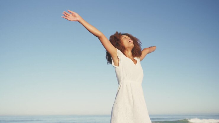 African American woman enjoying the fresh air of the beach