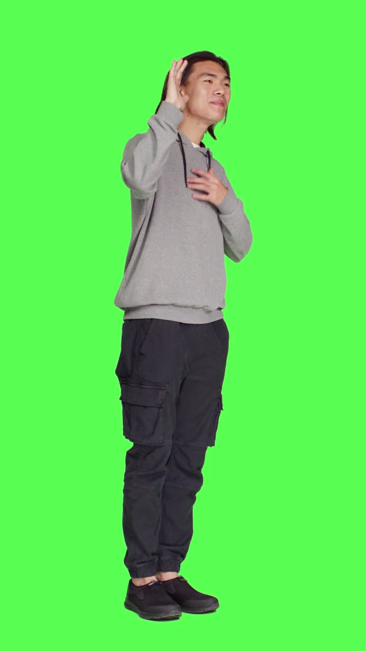 Side view of asian man waving hello at people