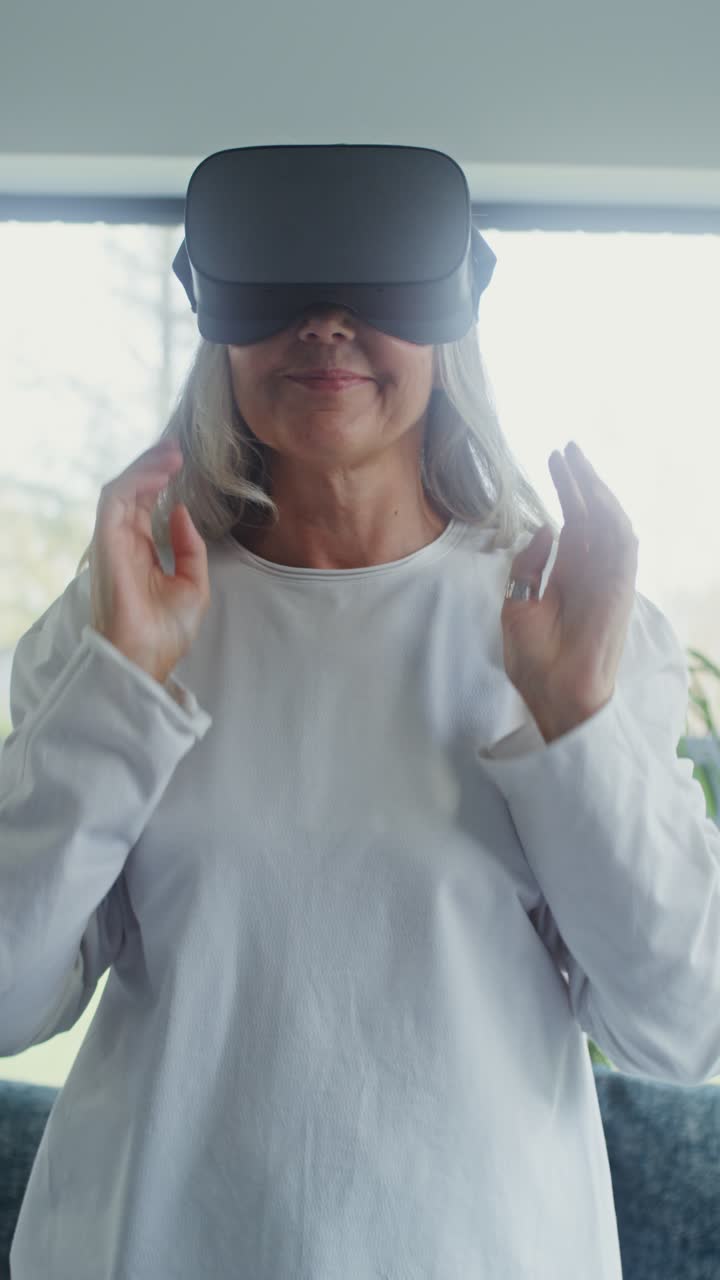 Elderly woman using VR headset at home
