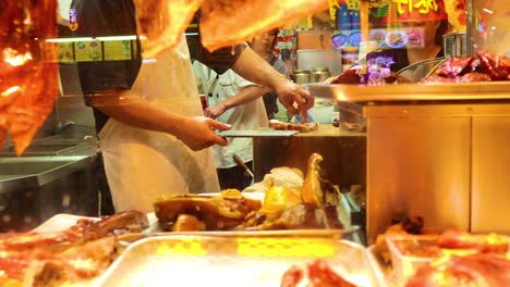 chef preparing crispy pork in a busy kitchen