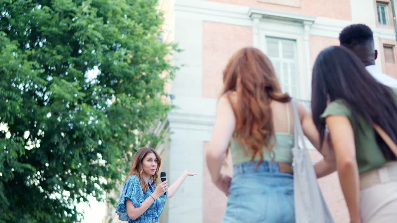 Woman Leading a Guided Walking Tour for a Group in a City