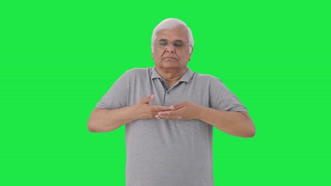 Indian-old-man-doing-breathe-in-breathe-out-exercise-Green-screen