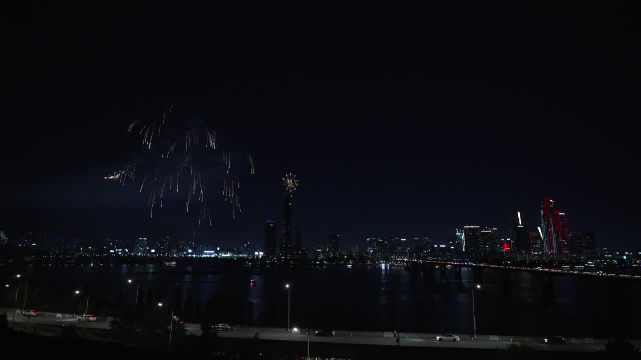 Spectacular Fireworks Display Over City River at Night