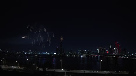 spectacular fireworks display over city river at night