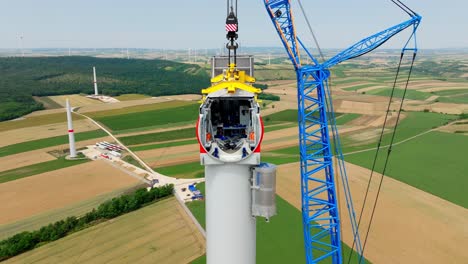Windmill-Construction-In-Agriculture-Fields---aerial-drone-shot
