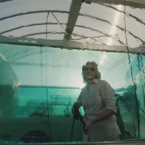 a woman washes her car in a self-service sink 2