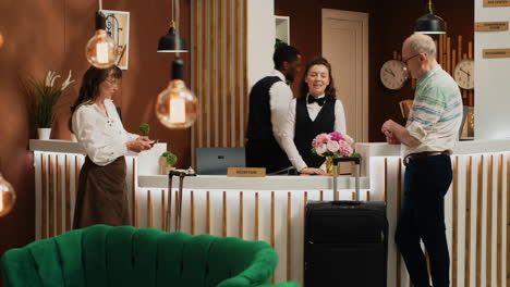 senior people receive room key card