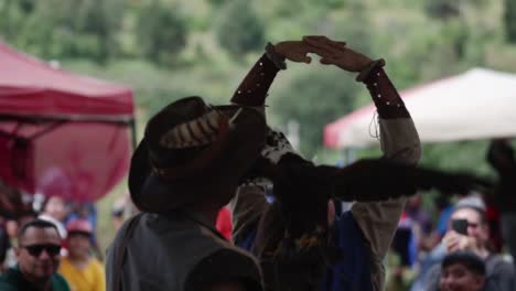 eagle passing between the arms of a woman at a raptor show. slow motion