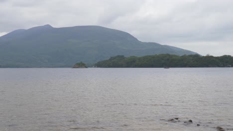 deep lake of muckross alongside rugged coves with mountain view in killarney national park, county kerry, ireland