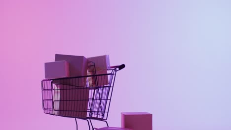 video of boxes and shopping trolley with copy space over neon purple background