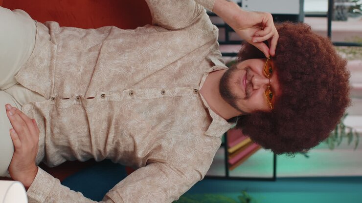 Smiling playful happy adult man blinking eye, looking at camera with smile, winking and flirting