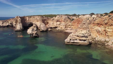 Flying-over-Praia-Da-Marinha--in-Algarve,-Portugal