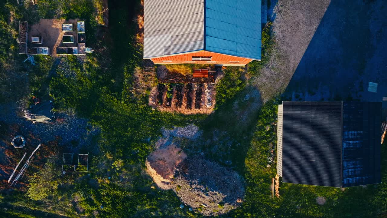 Descending On The Yard With Garden Plants Growing. Aerial Shot
