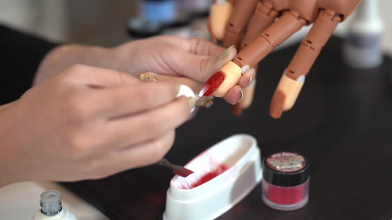 Female Hands Paint With red Varnish False Nails Glued To A Prosthetic hand 4k
