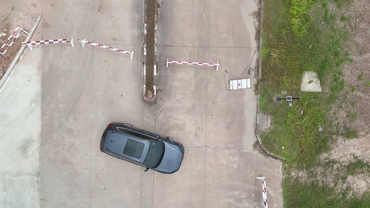 Drone descends onto car from aerial view