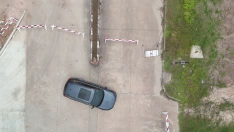 drone descends onto car from aerial view