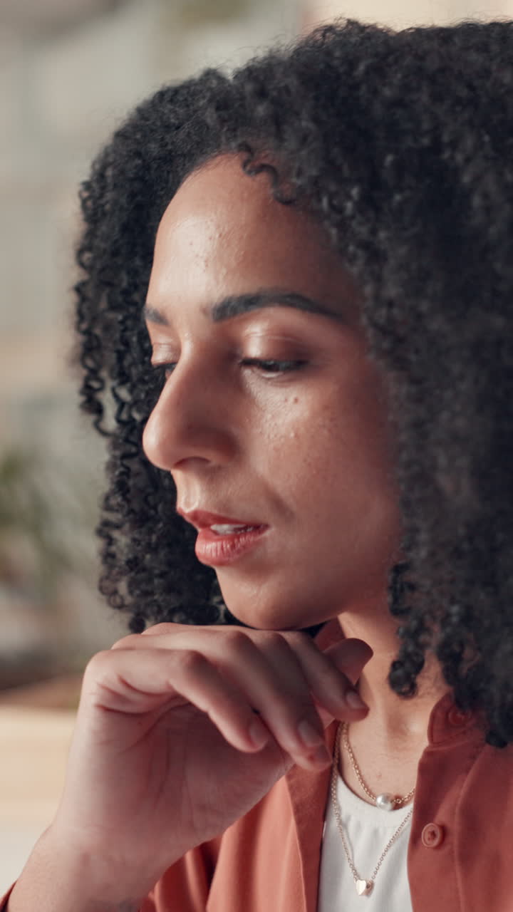 Close-up of Thoughtful Woman with Curly Hair Pondering and Smiling