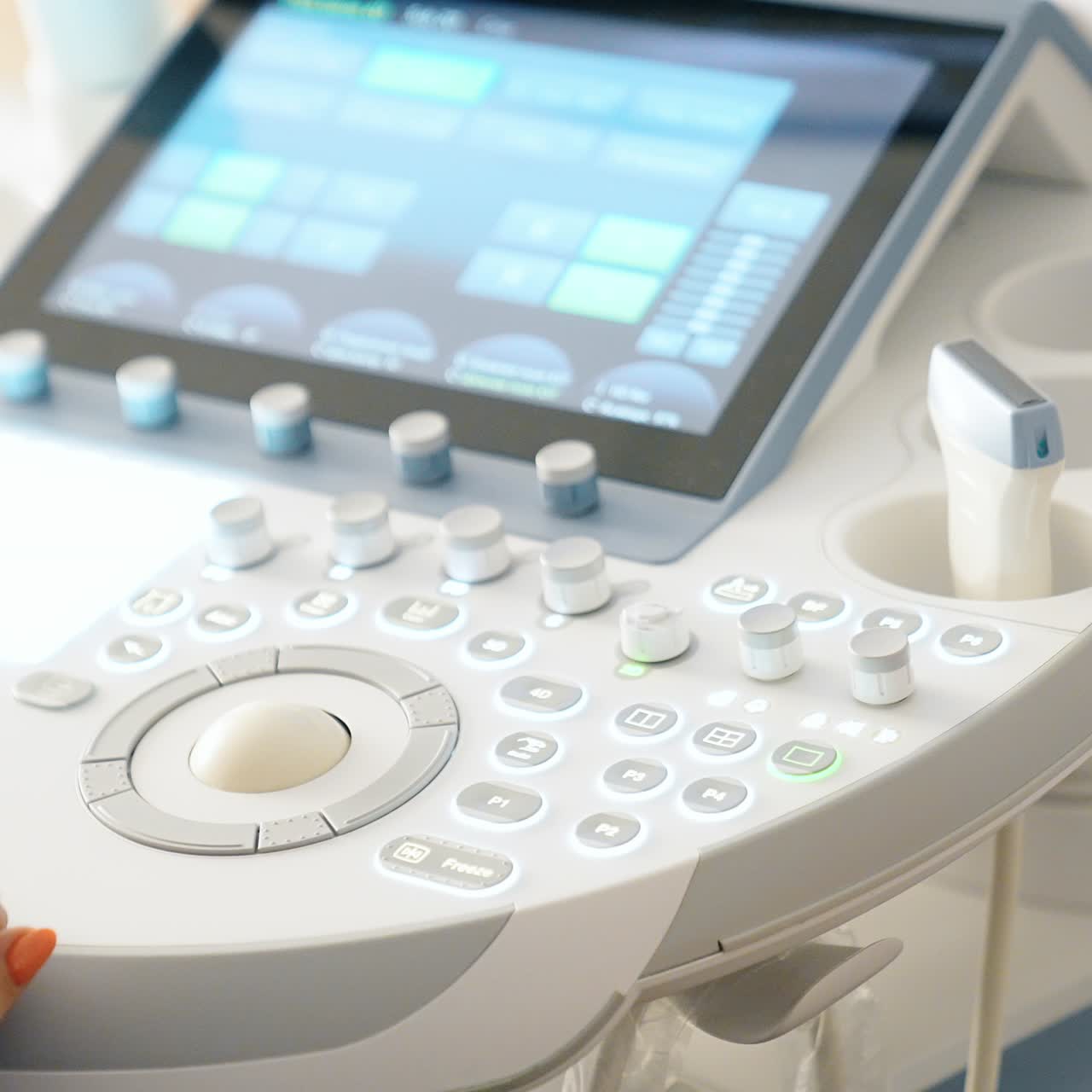 Doctor's hand operating the ultrasound machine. Unrecognized medic performs ultrasonic check up. Close up