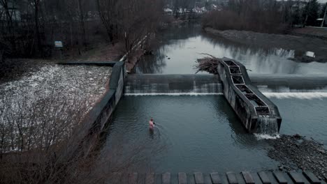 Aerial-Footage-of-Boy-Getting-into-Cold-Water-and-Ice-Bathing