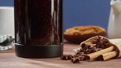 brewing black tea in a teapot close-up. drinking hot herbal drink on blue background