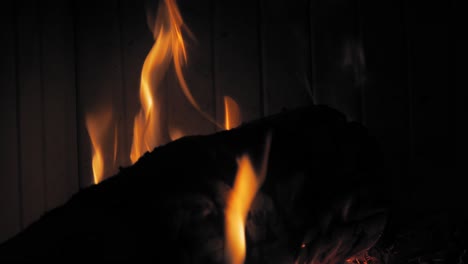 burning flame at fireplace on wooden logs