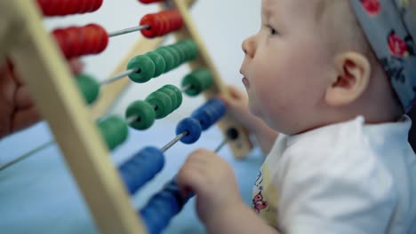 child plays with a multi-colored toy 6