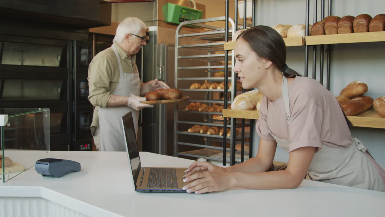 People Working in Cozy Bakery with Fresh Bread