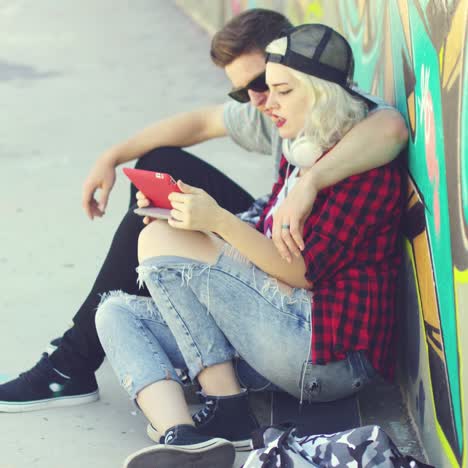 affectionate hipster urban couple relaxing in town