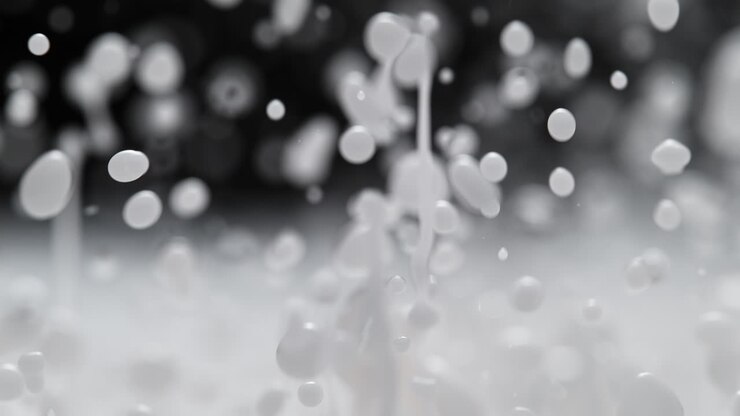 Milk Splashes And Creates Standing Waves, Abstract White Liquid In Macro and Slow Motion on the Black Background